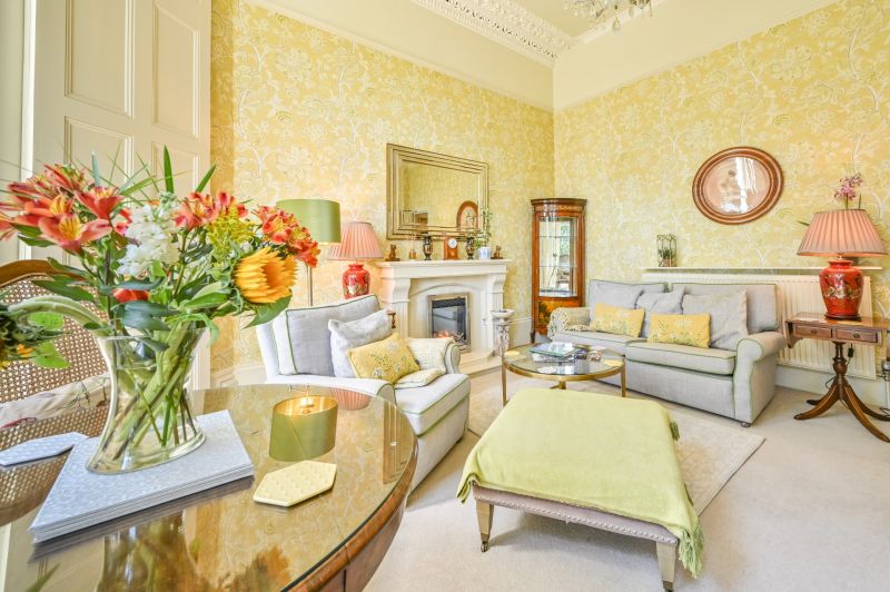 Living Room with seating area and dining table - Apartment 2 - The Muntham Luxury Holiday Apartments in Torquay.