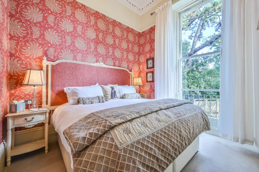 Apartment 3, The Muntham Luxury Holiday Apartments in Torquay. Bedroom has working original shutters.