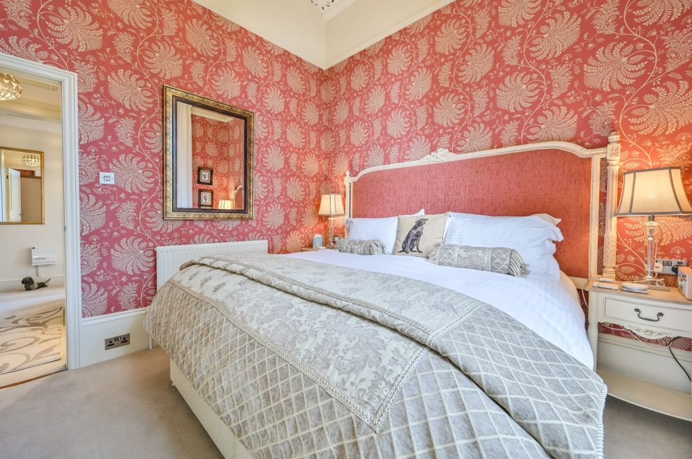 Apartment 3, The Muntham Luxury Holiday Apartments in Torquay. Bedroom with views over the Rose Garden at the side of the property.