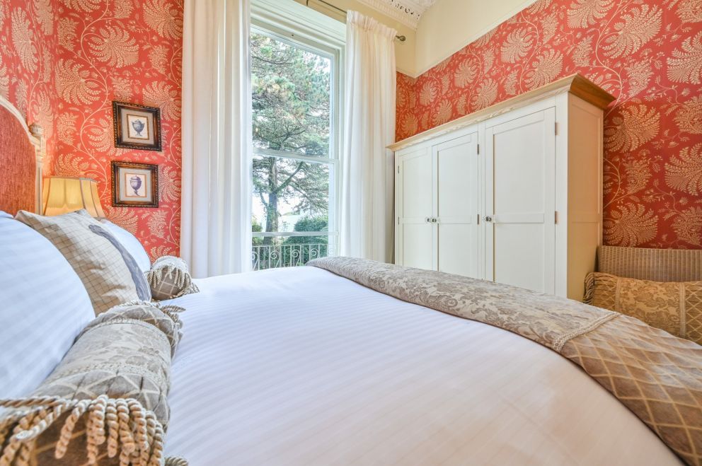 Apartment 3, The Muntham Luxury Holiday Apartments in Torquay. Bedroom with plenty of storage space.