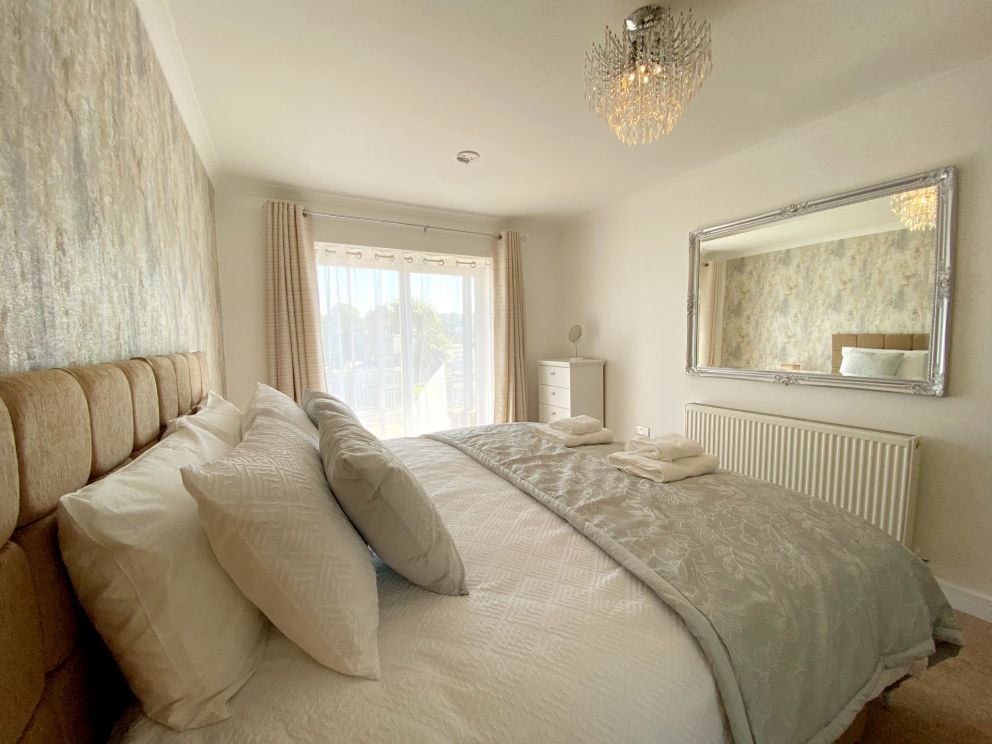 Ockendon House Apartment B - beautiful bedroom with French doors onto a sunny terrace.